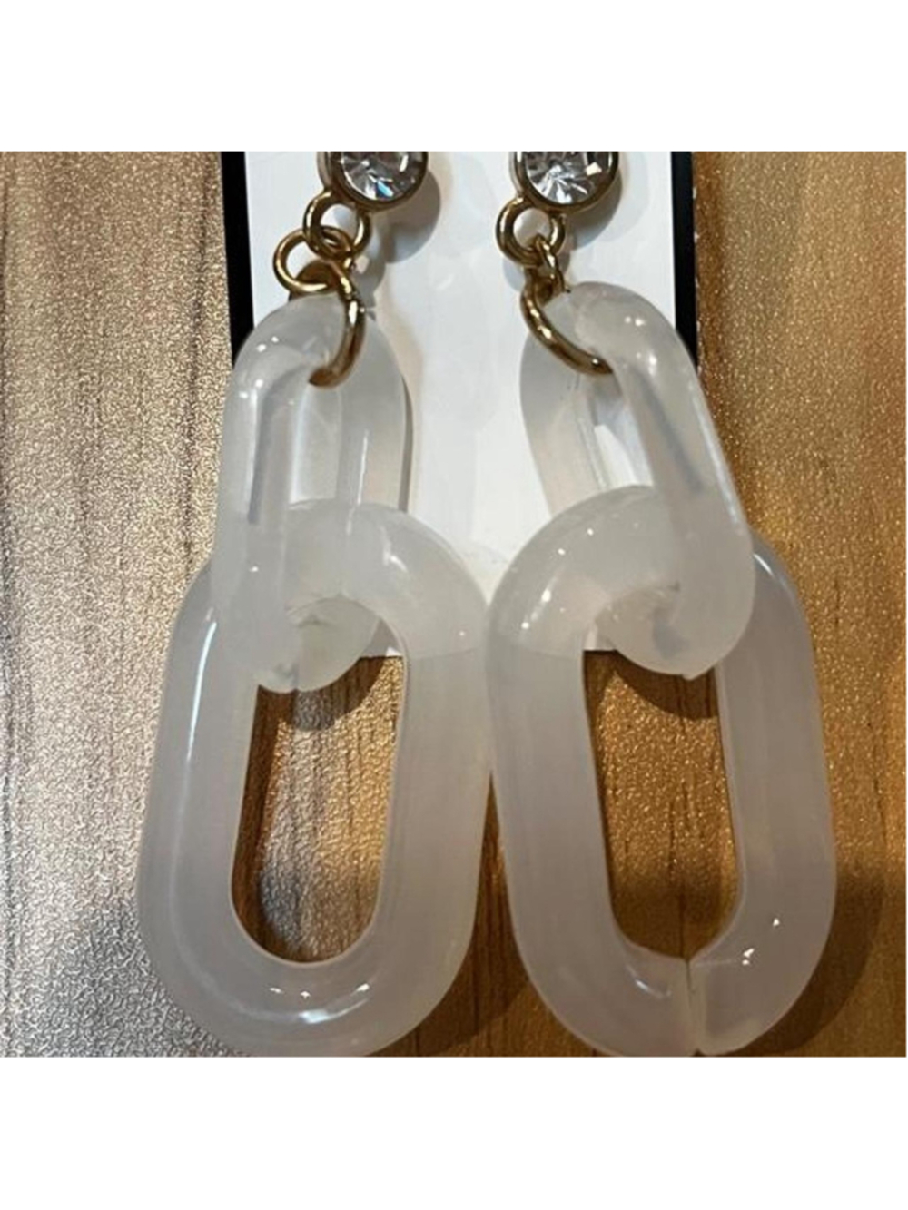 Chunky translucent white chain-link drop earrings with rhinestone studs